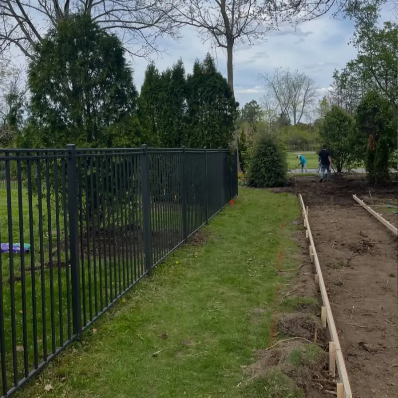 Backyard landscaping with fence and garden bed installation