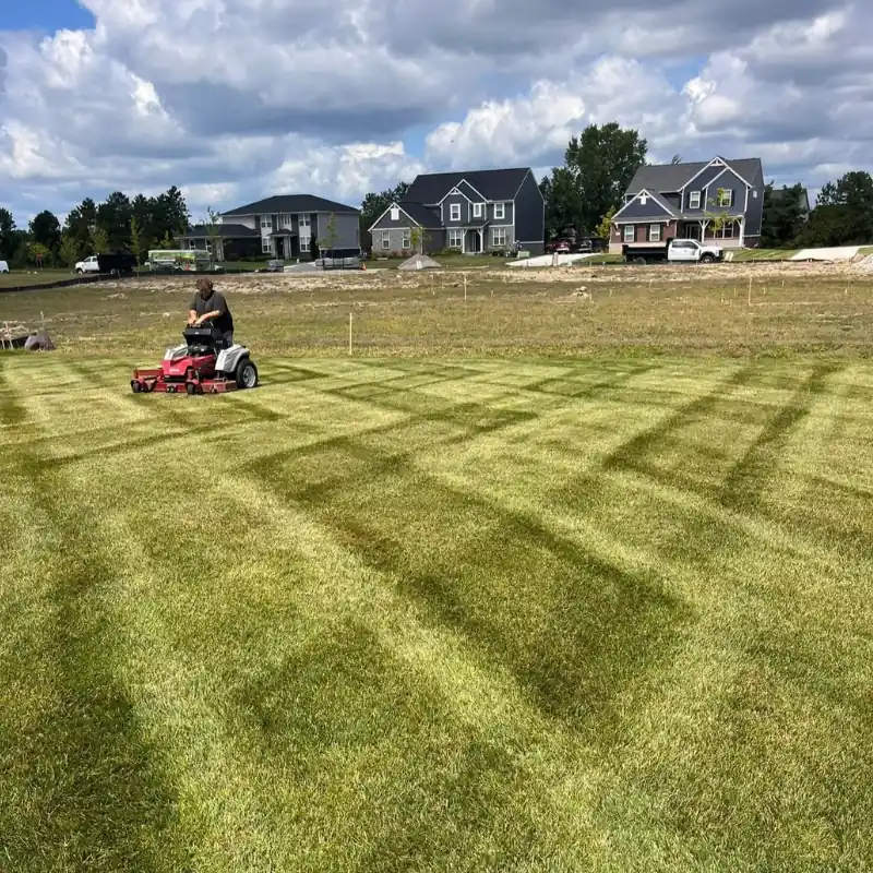Professional lawn mowing with clean stripe pattern