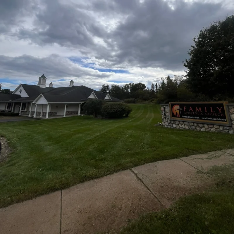 Exterior landscaping with planting beds and lawn
