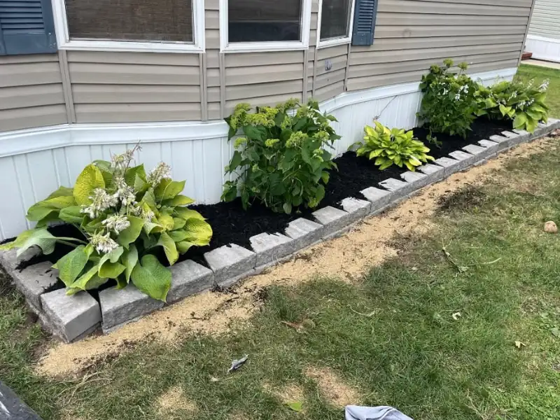Foundation flower bed border with hydrangeas and hostas
