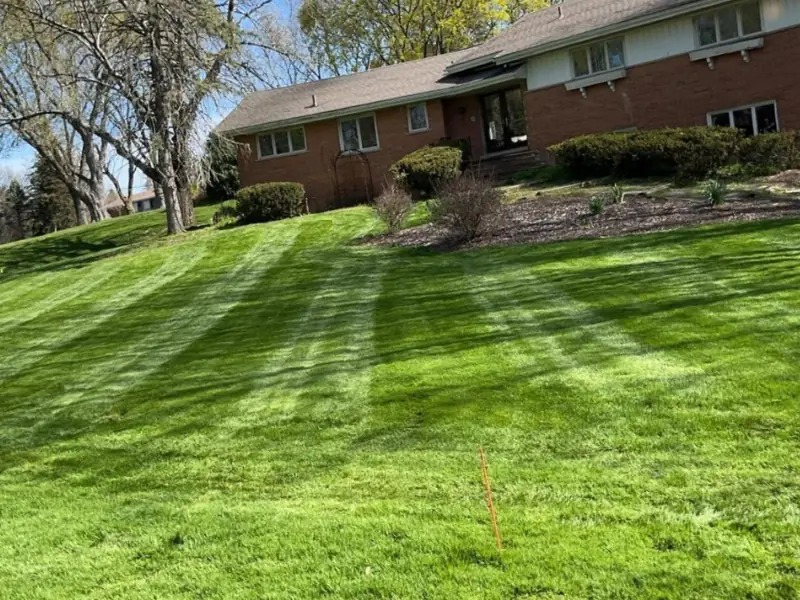 Well-maintained residential lawn and landscaping by Legacy Lawn And Landscape